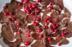 Reindeer is topped with lingonberries, and then eventually with a hearty gravy