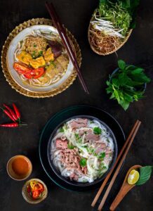 Crab soup and beef noodle (Bun rieu, Pho bo) serving with chili sauce, Image by ngoc tran, Shutterstock