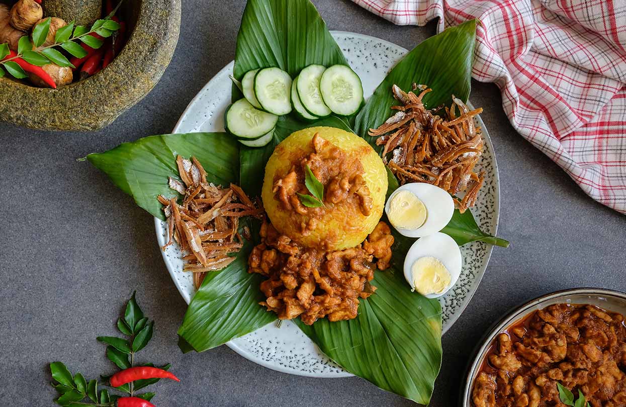 Traditional Malaysian Peranakan cuisine Nasi Kunyit aka Turmeric Glutinous Rice, image by YSK1, shutterstock